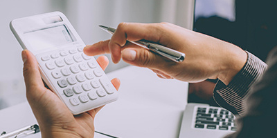 a professional holding a calculator for budgetting