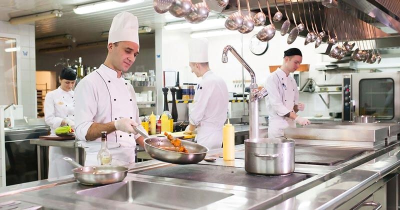 chef and kitchen staff cooking in the commercial kitchen