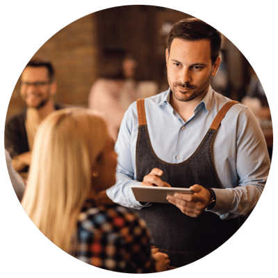 A wait staff taking order from a customer at the restaurant