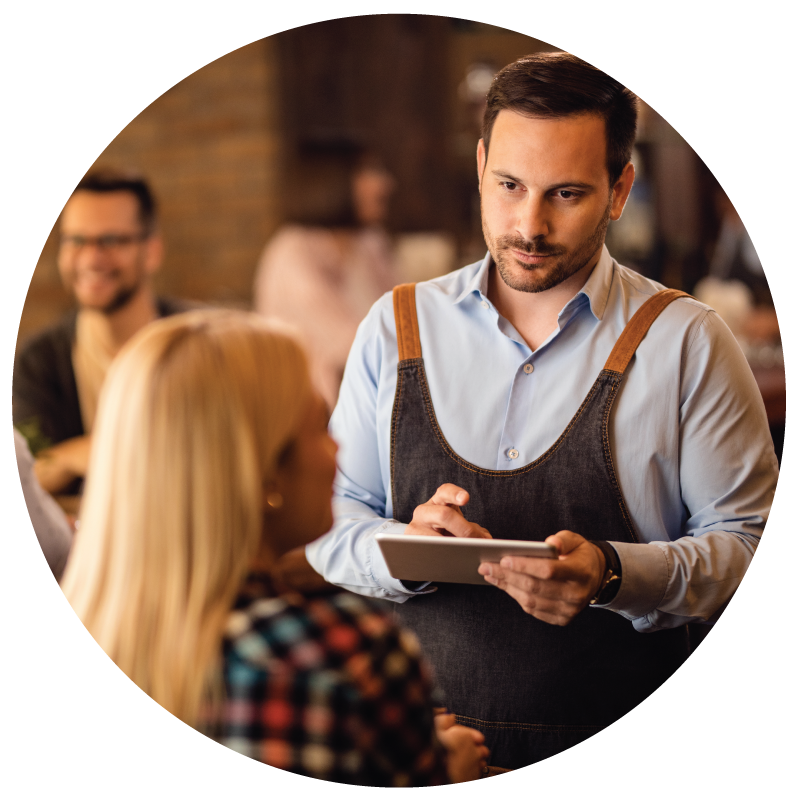 A wait staff taking order from a customer at the restaurant