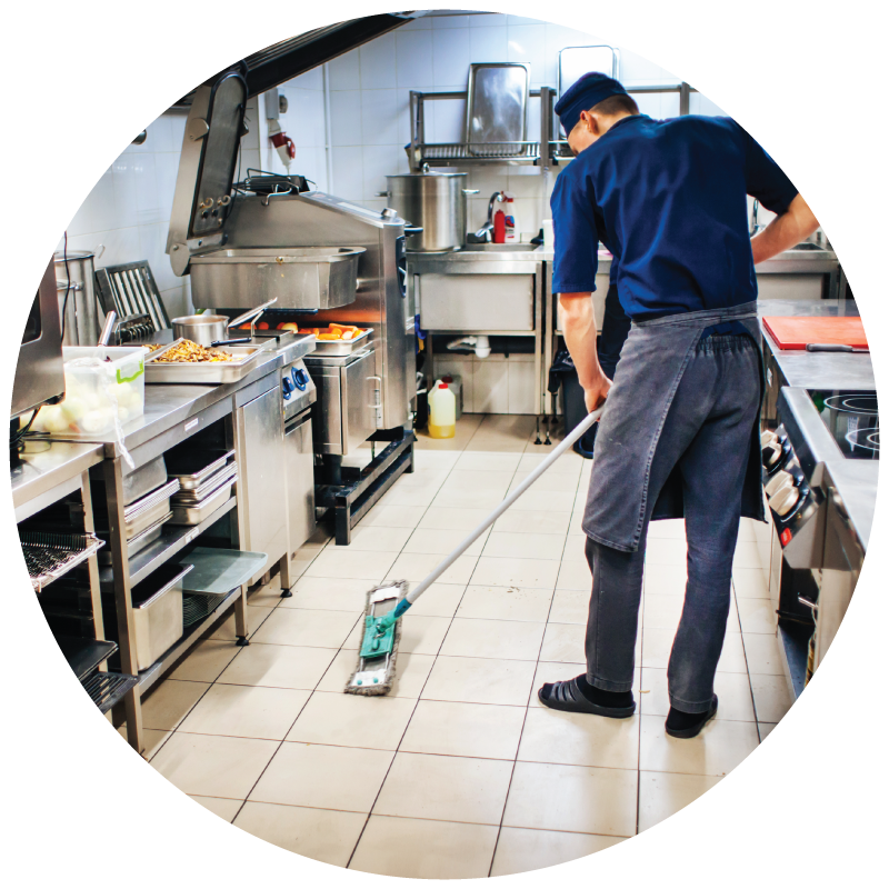 a restaurant staff mopping the kitchen floor