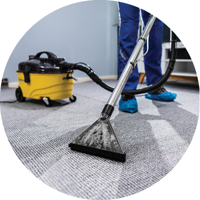 custodian vacuuming the carpeted floor