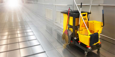 A professional cleaning cart in a commercial building hallway