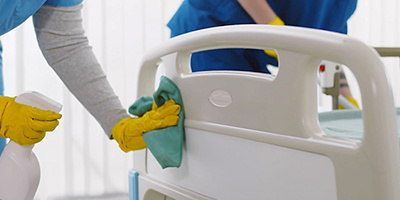 healthcare staff disinfecting patient rooms