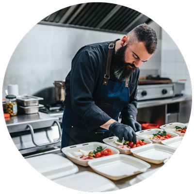 a cook preparing for to go orders at the restaurant kitchen