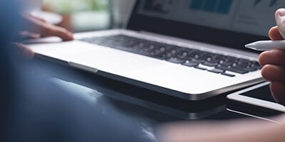 a person looking at a report on his laptop