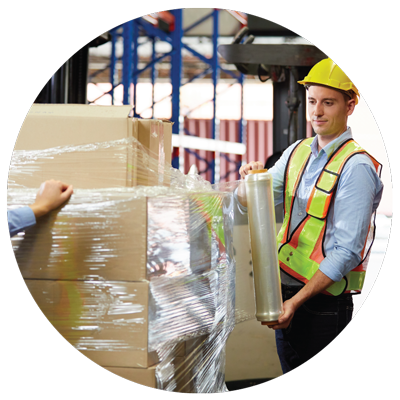 a warhouse worker using stretch film to wrap a pallet