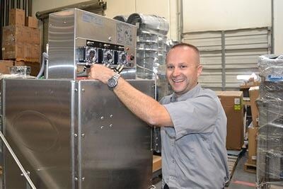 a technician servicing warewash machine