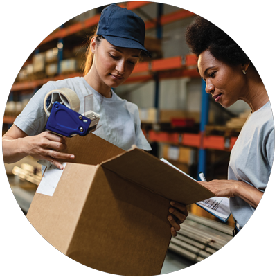 two female warehouse workers working on packing a shipment