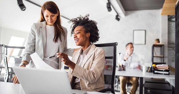 a few business women discussing a project in the office