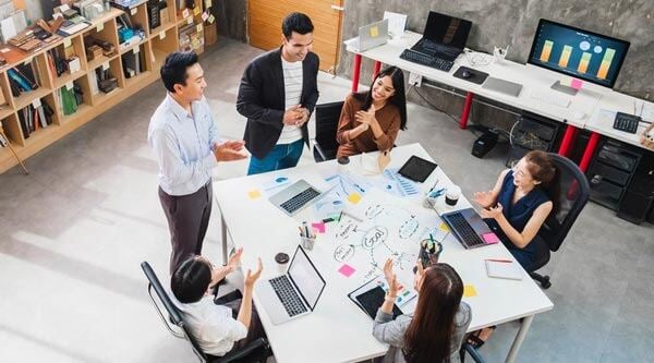 six business people having a meeting in an office