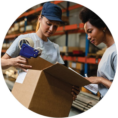 two female warehouse workers working on packing a shipment