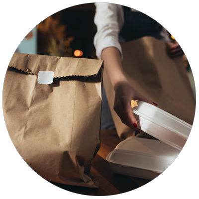 restaurant staff packing to go orders using disposables