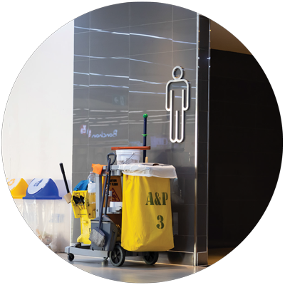 cleaning cart in front of a restroom in a commercial building