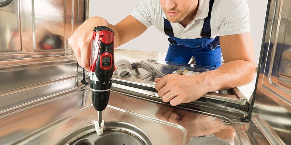 a technician maintaining comemrcial dish washer